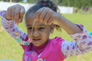 Making a fruit loops bracelet can help your special needs child or toddler strengthen common developmental issues like hand-eye coordination and focus. 